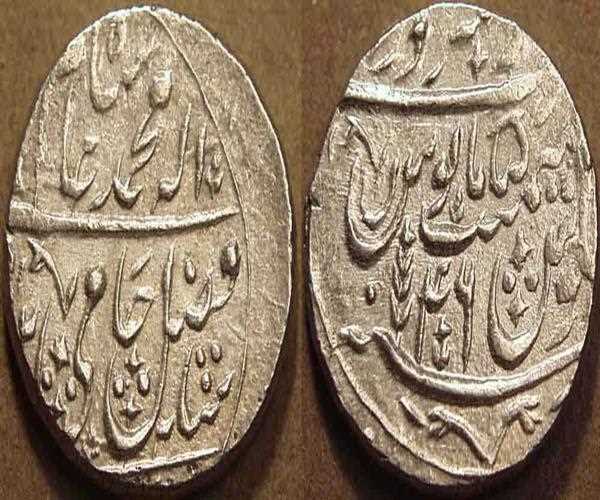 In the name of which Mughal emperors, the East India Company struck the first coins in India?
