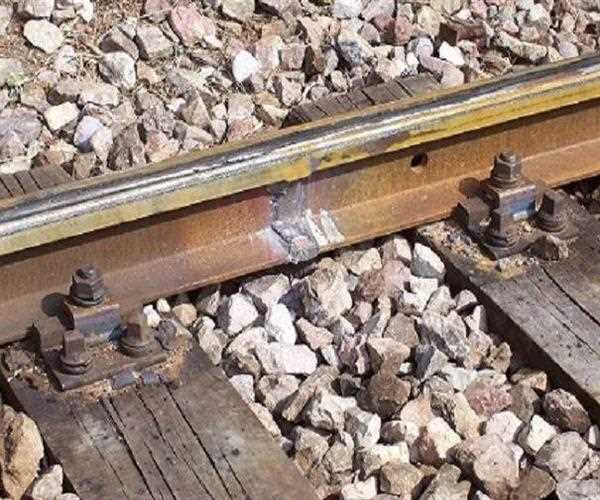 Why are there crushed stones alongside rail tracks?