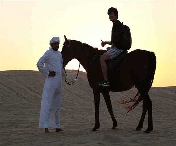 What other activities can I perform in Dubai desert other than sandboarding and dune bashing?